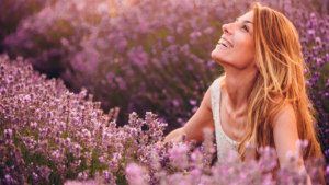 A woman sitting on a lavender field, enjoying life